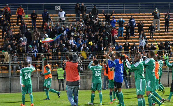 Comoran players celebrate with fans inside Stade Francis Turcan following a friendly match against Burkina Faso in 2014. The match finished 1-1 as Comoros played its first match in 15 months.