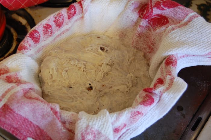 Put a lot of flour on the cloth. Otherwise, the bread might stick to the cloth when you're trying to transfer it into the oven and you might tear the skin.