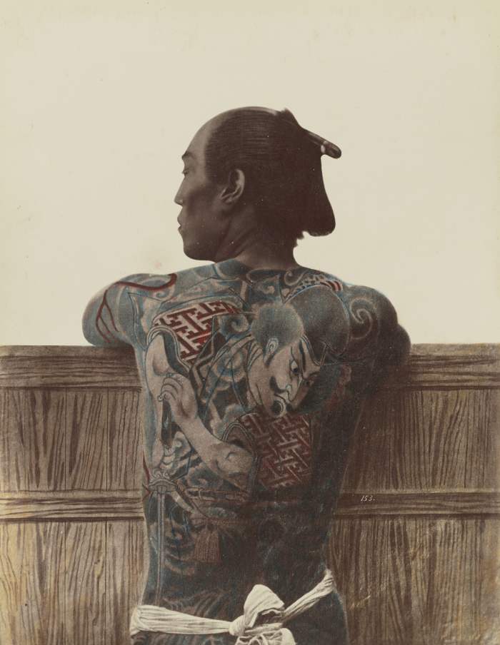 A photograph by Kusakabe Kimbei taken between 1870 and 1899 of a tattooed Japanese man. In Japan and China, tattoos were considered to be a spiritual enhancement.