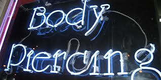Most tattoo shops that offer piercings will have a sign displayed such as this.