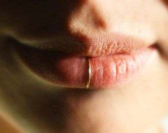 An alternative option to the traditional lip ring; placing the piercing in the center of the lip looks quite beautiful.