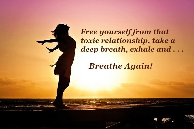 A woman breathes in the fresh air of the ocean as she celebrates letting go of a toxic relationship.