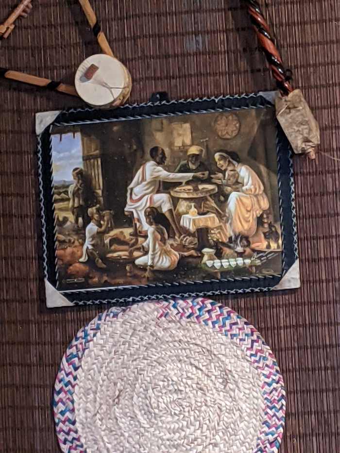 Painting of an Ethiopian Family and visitor dining in the traditional way
