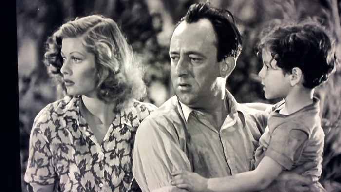 Peggy (Lucille Ball) and Pete (Allen Jenkins) wait patiently as the pilots test their handywork as Tommy (Casey Johnson) waits for another story from Pete.