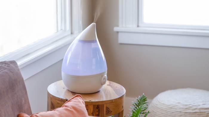 A humidifier is a device that increases the volume of water vapor in the air in a living room indoors.
