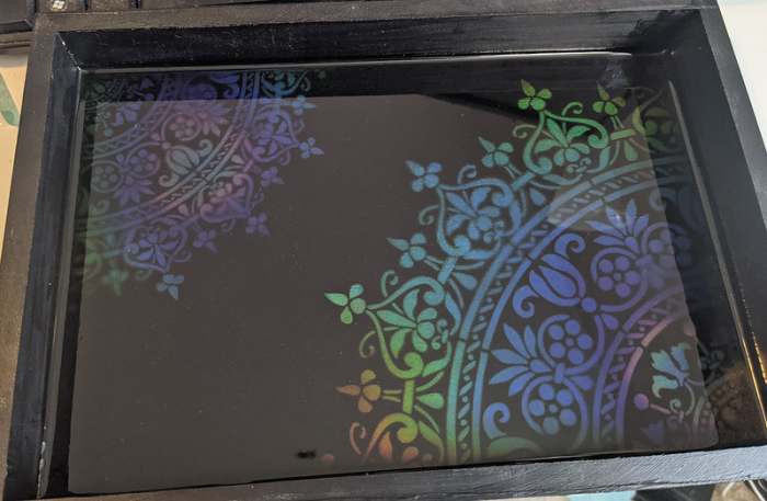 It can be difficult to capture the color changes in a picture, but I also made a tray by airbrushing over a stencil and coating in resin. You can get the effect here in the morning sun.