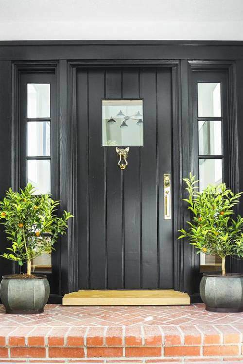 Similar to this dark black gray front door paint makes a dramatic statement against light siding or wood.