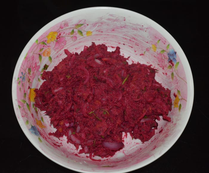 Mix well. Make a pliable dough. No need to add water to make the dough because the grated beetroot, carrot, and chopped onions contain enough moisture to make the dough wet.