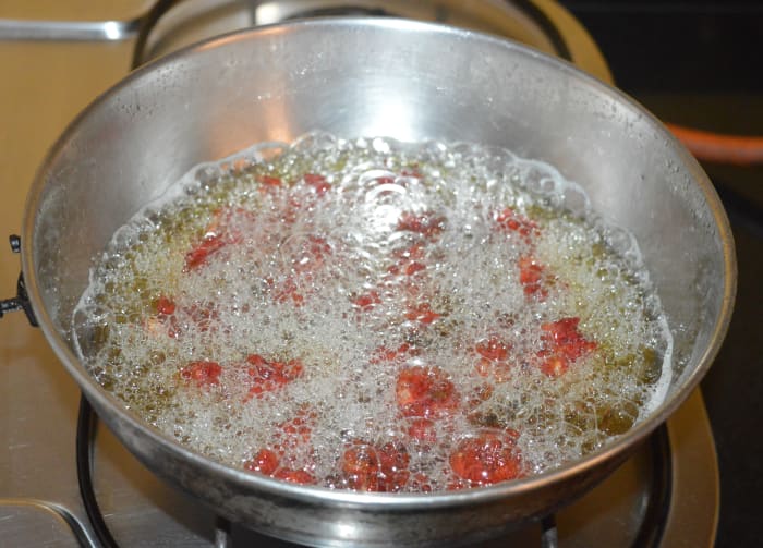 Step two: Heat the oil for deep-frying in a deep-bottomed pan. Pinch out small portions of the dough. Drop each of them one after the other into the hot oil. After a minute, turn them to ensure cooking on all sides. Fry them until they become crispy.