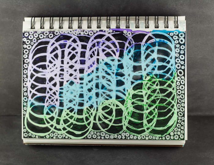 I used a cardboard tube to create the circles on this sketchbook page.