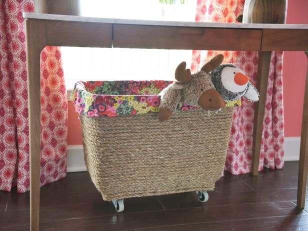 Make a mobile toy box out of a container. Add jute cord, metal casters and a decorative cloth lining to a plain plastic storage bin to give it new life.