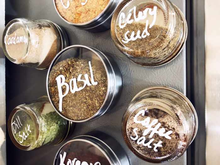 We wanted to make our new spice storage magnetic so that it could be attached to the side of a cabinet, and we found these adorable transparent containers so that you can see how much of each spice you have on hand.