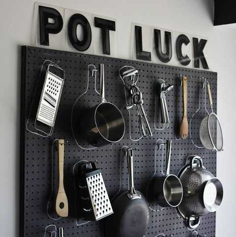 A black pegboard transforms a bare, blank wall into a stylish room. Hang your pots and pans on hooks and draw a chalk circle around them so you don't forget where they belong.
