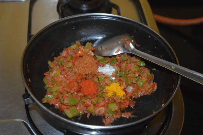Step three: Add turmeric powder, red chili powder, garam masala powder, and remaining salt. Combine well and saute the mixture for a minute.