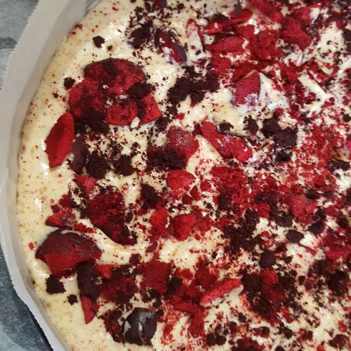 Tin is filled with about two-thirds of the batter. Freeze-dried plum slices and Davidson Plum powder are scattered over. Then the rest of the batter is poured over to cover.