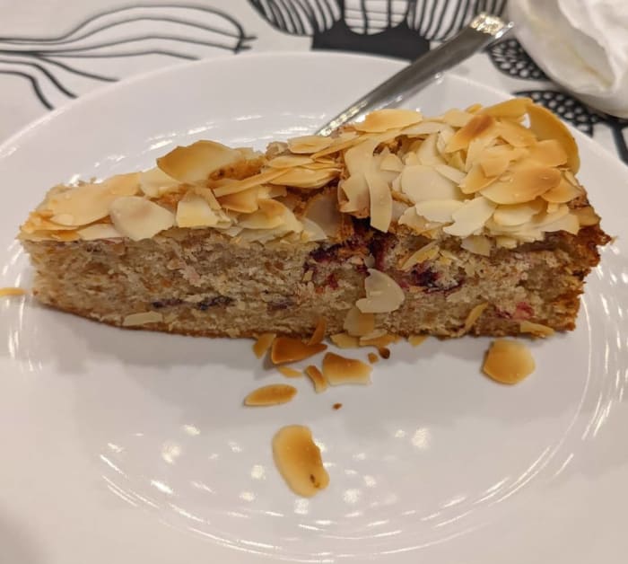 Slice of brown butter almond cake with freeze-dried plum slices and Davidson plum powder