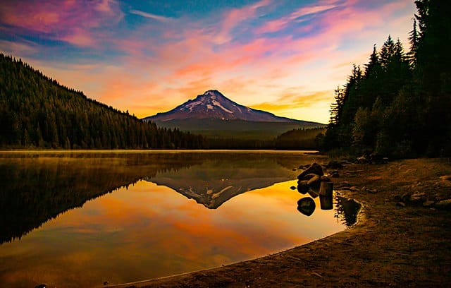 Early morning sunrise on Trillium Lake with the reflections of Mt. Hood, the trees, and the colorful clouds