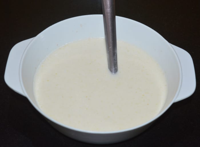 Add half a cup of water and make a lump-free batter. Set aside covered for 15 minutes. After resting, the batter will become thicker. Add enough water and mix well to get an idli batter consistency (dropping consistency).