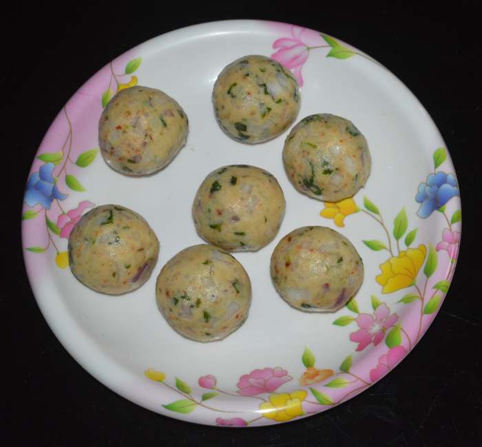 Step three: Apply some oil to your palm. Pinch out a lemon-sized portion of dough and shape it into a ball. Make equal-sized balls with the rest of the dough. Collect them on a plate.