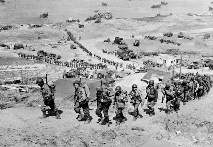 Troops 2nd Infantry Division and their equipment going up the bluff via the E-1 draw on D+1, June 7, 1944.