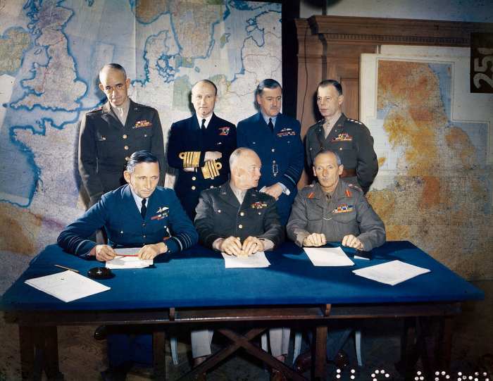 Months before D-Day Eisenhower meets with his generals to plan out the invasion of Normandy, France. Eisenhower is seated in the middle of the front row.