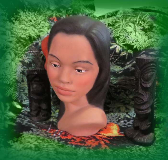 . She is a beauty with long black hair adorned with two pretty soft red hibiscus flowers along one side of her head. Her lips are a flesh tone. This is a beautiful example of a handmade, and made in Hawaii Polynesian girl head bust. She is about eigh