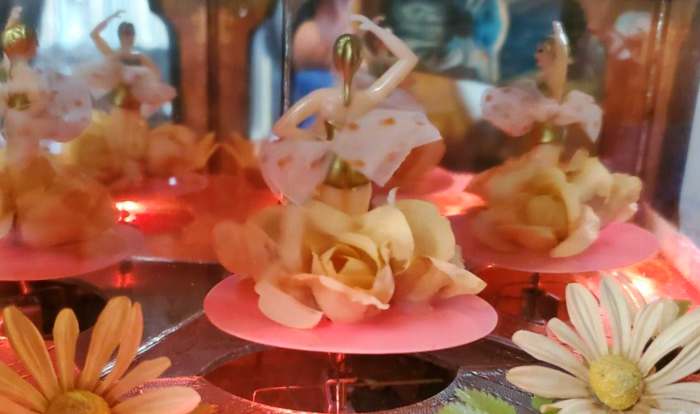 The magical stage inside the jewelry box is a enclosed world of it own. The beautiful dancers appear to be dancing to a audience on a stage in Tokyo.