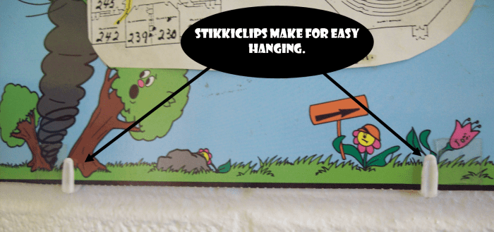 StikkiClips make it easy to hang artwork on just about any wall. The one in the background here is cinder-block.
