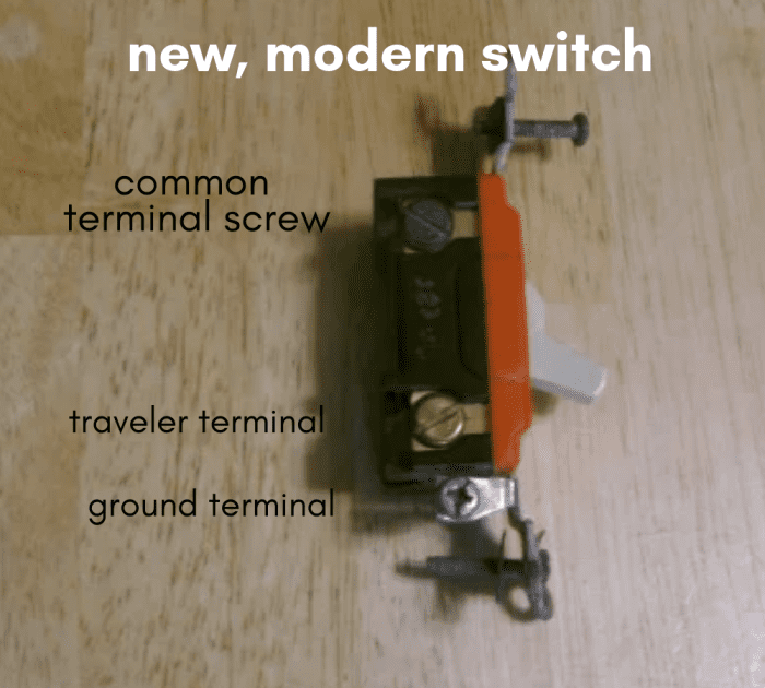 The common terminal is on the top in this view, with a traveler on the lower end. The ground terminal screw is showing up as silver-colored at the very bottom.