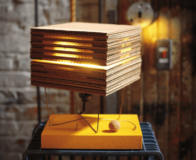 You can make your own DIY cube lamp out of corrugated cardboard, a wire coat hanger, and a few additional parts, and this article will show you how.