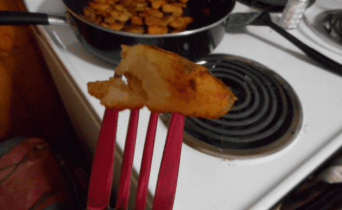 It's simple: fry the potatoes until they're a rusty tan color, crispy on the outside, soft inside, and then cover them in buffalo wing sauce!