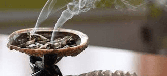 Just pass the crystals through the sage burning in the container, while asking the stone to do what you need it to do.