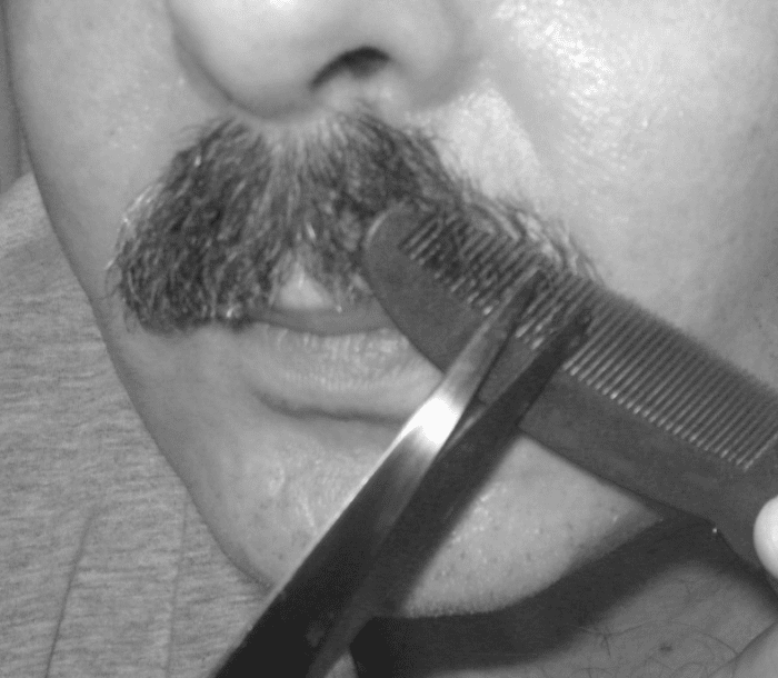 Thinning a mustache: Hold the comb upside down and push it under the mustache.