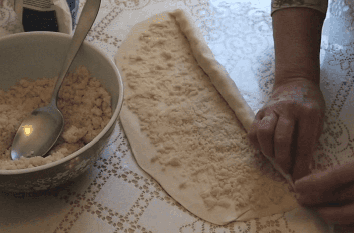 Rolling the pastry with the filling spread across