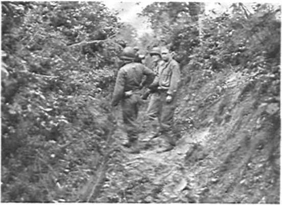 Crew laying wire near St. Lo, June 1944. The steep hedgerows helped conceal the crews but also the enemy. Many times the Germans were able to ambush the crews and cut the wire.