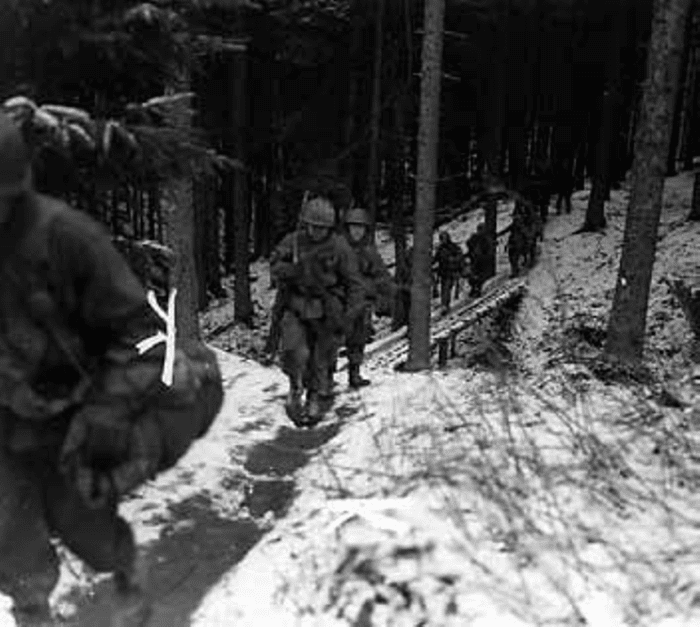 A squad of the 424th on the move in Berk, Germany, March 1945.