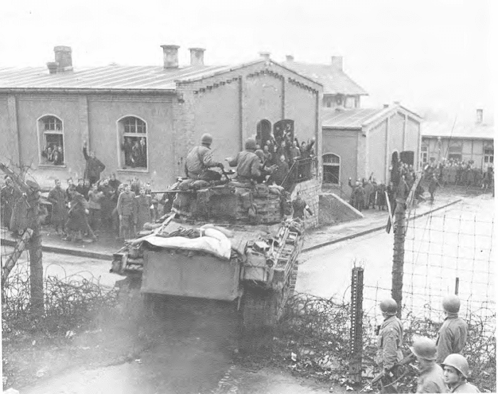 American troops finally liberate Hammelburg prison camp. But most of the Americans had already been moved. However, Patton's son in law was still in the hospital, so he was flown out as soon as possible. The jubilant POWs shown here are Yugoslavian.