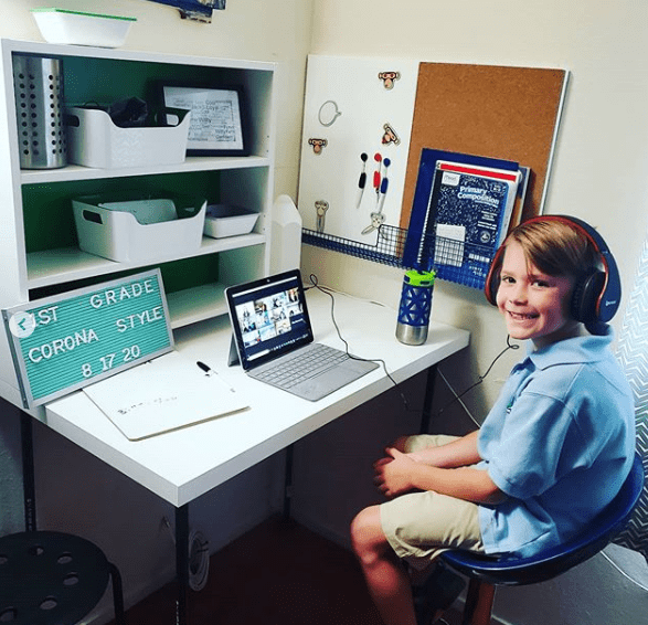 My nephew's home learning space, which includes a cork board, a white board, a letter board, and some storage bins.