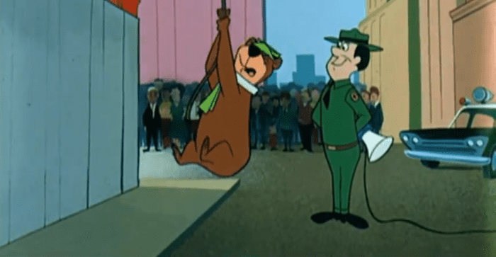 Yogi, thinking he's higher up than he is, desperately agrees to Ranger Smith's suggestion for the bears to return to the park without taking down the signs.