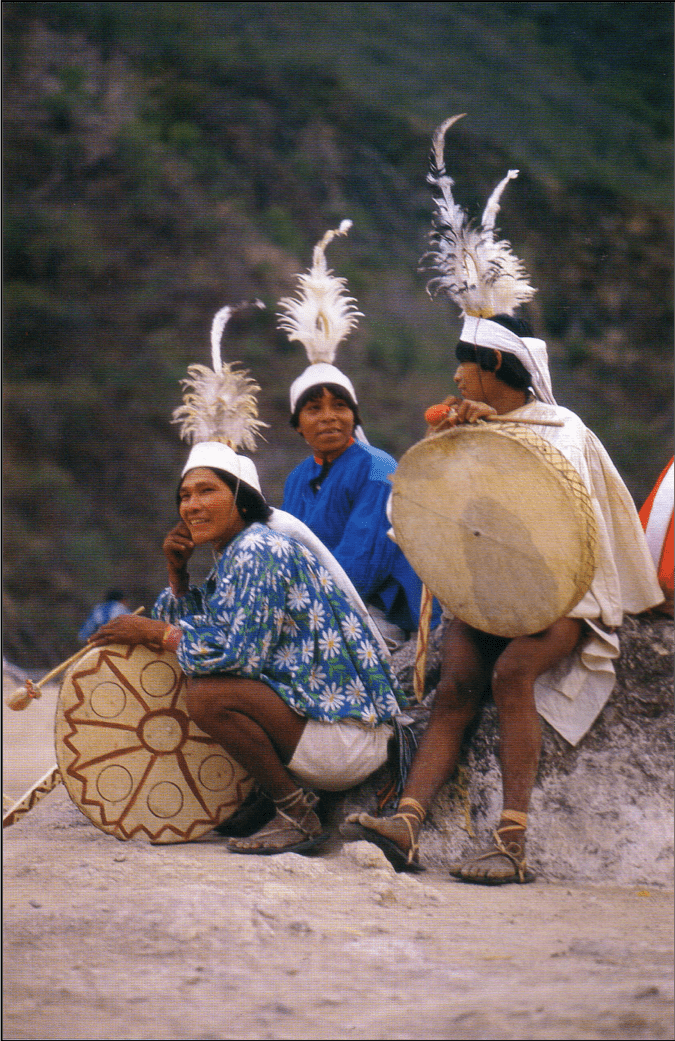Several Tarahumara youths with their newly made drums await the start of the festivities.