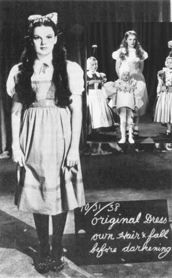 "Inset: Judy Garland, wearing a blonde wig and heavy makeup, stands with Munchkins for a color test during Thorpe's reign as director. At left: as she appeared after Cukor's three days on the picture."