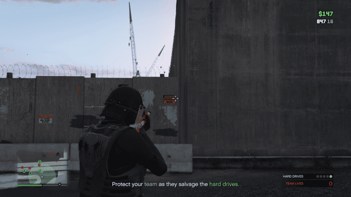 Once around the other side you can climb over this wall to get back into the area with all of the wrecked vehicles. Note: Hop onto the cement divider THEN climb the wood wall if you're having trouble.