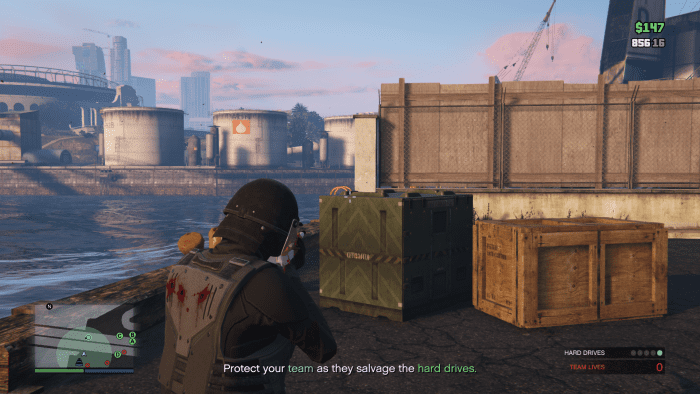 On the other side of that green crate is just enough dock to walk along. Here you can flank around to the other side of the area without getting shot too much.
