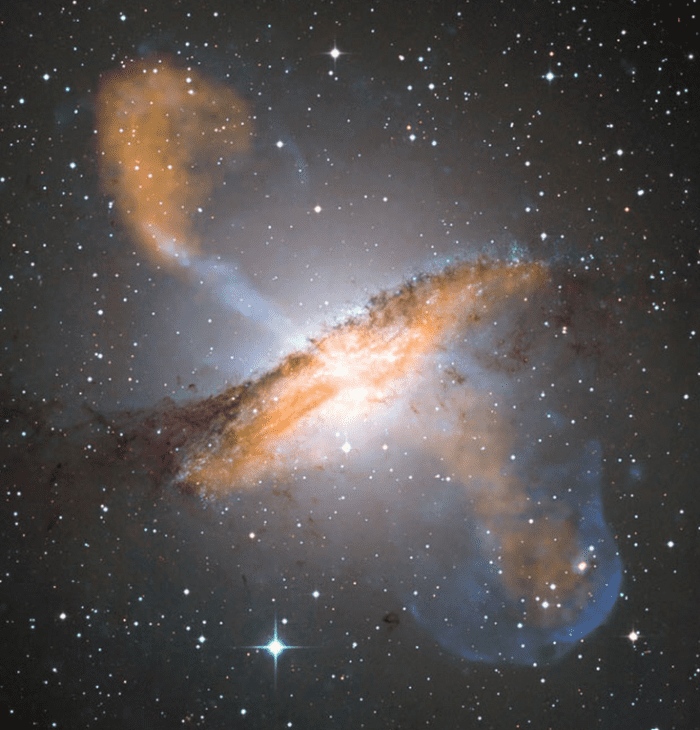 X ray wavelengths (blue) and microwaves (red) superimposed on a visible-light image of Galaxy NGC 5128 reveal the ghostly jets of a giant black hole the mass of 55 million suns.