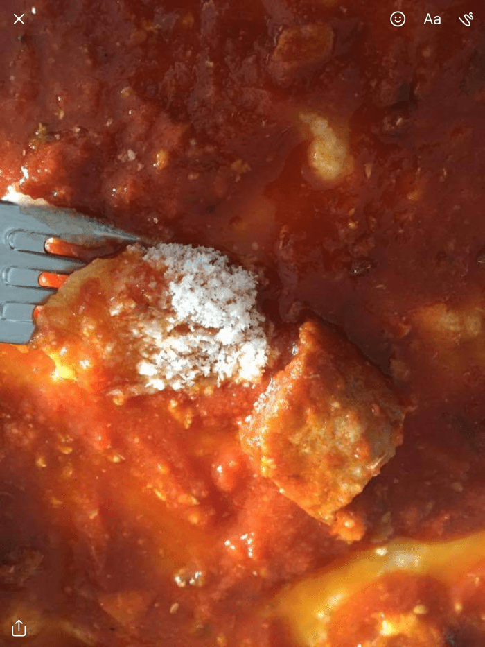 Polenta with a tomato chopped vegetables and beef and pork based meat based sauce common in Abruzzo Italy.
