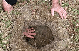 Where you see his hand is the breathing hole for your fire hole. This method used burns firewood more efficiently puts out more heat and very little smoke.