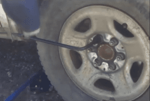 To complete the lug nut tightening give the wheel wrench handle a slight kick downward with your foot