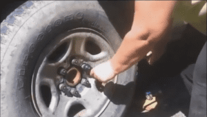 With both hands on the horizontal handle of the wheel wrench use all of your upper body weight to push downward until the lug nut refuses to turn.