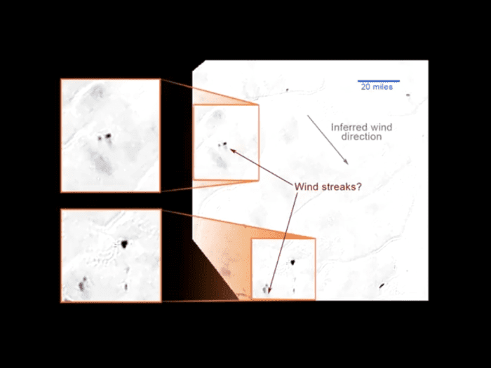 Wind deposits on the backsides of obstacles, or... plume deposits from a geyser? VERY speculative; we don't know yet. (Screengrab from streaming video, and the original image had JPG compression artifacts, so take details with a grain of salt)