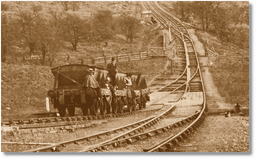 Near Incline Bottom, a rake of 8 ton steel mineral wagons carries 'passengers' up the incline past the weigh hut